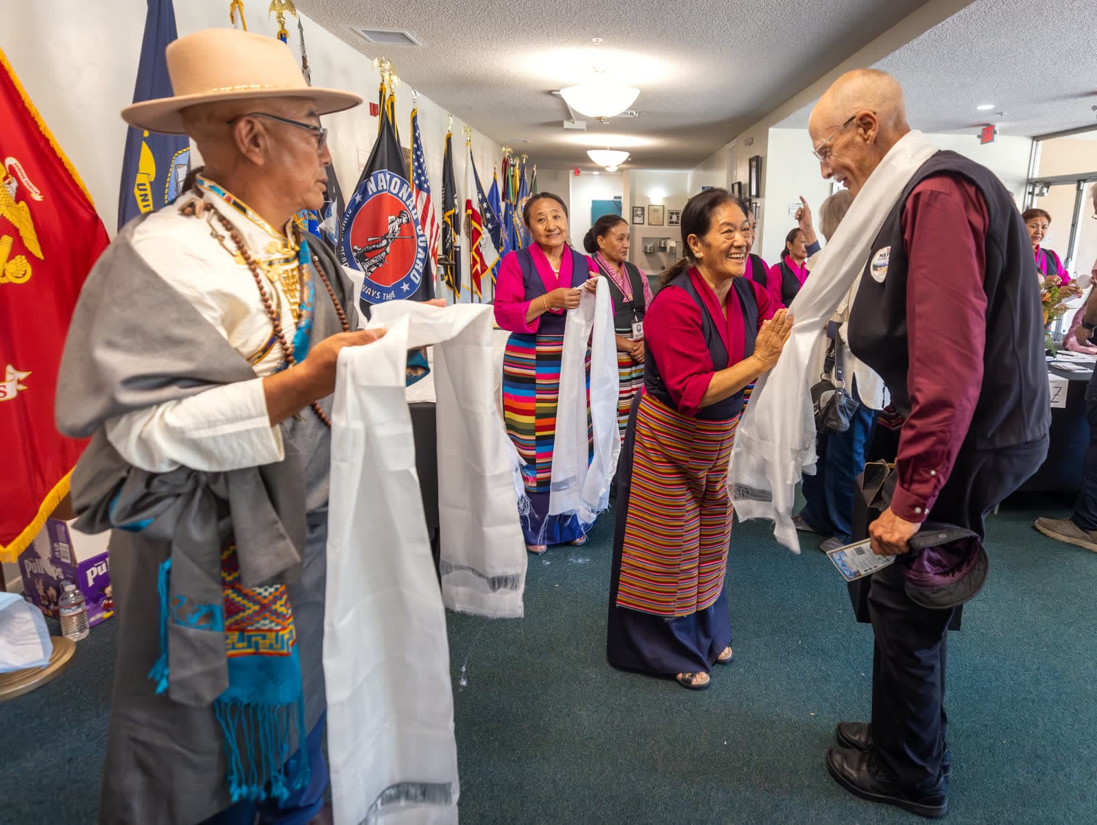 Nepalese community members greet a guest with a white ceremonial scarf at the Sonoma Veterans Memorial Hall fundraiser for Nepal flood relief